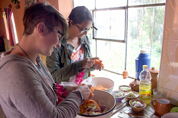 Cami Conroy and Rashi Ghosh lend a hand in the kitchen at Isla Amantaní.