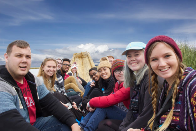 The students tour pristine Lake Titicaca in a reed boat.  Shown, l-r: Dennis Mitchell, Dani Carson, Meg Martinez, Anthony Azzun, Katie Gerth, Rashi Ghosh, Linh Luu, Dylan DeLay (partly obscured), Cami Conroy, Rachel Lindsey and Summer Webers.