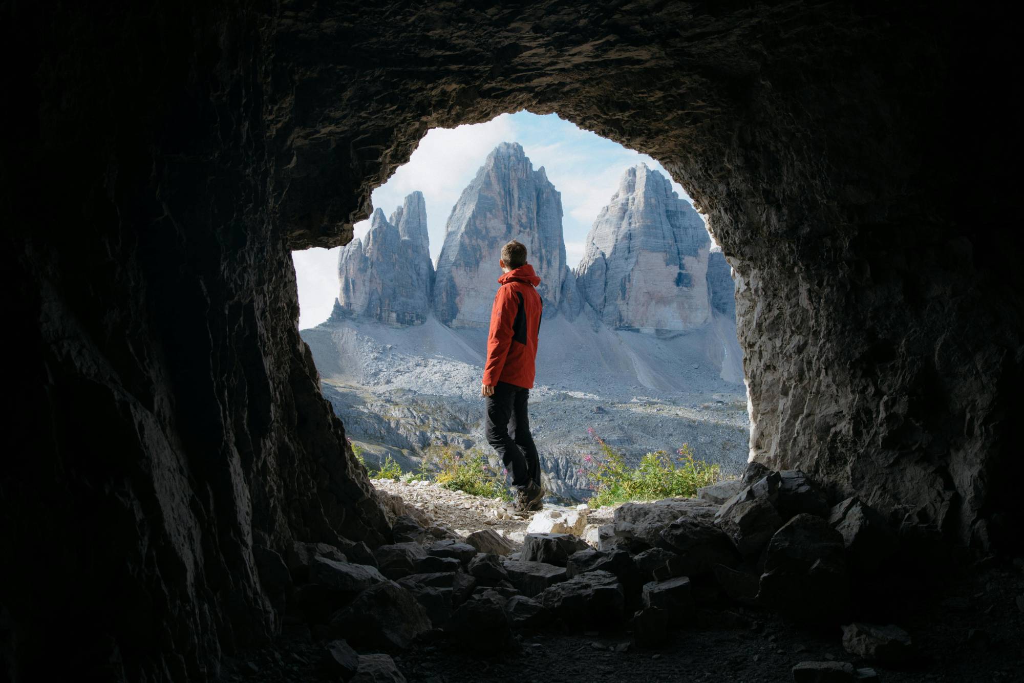 Man standing in a cave in the Dolomites. 