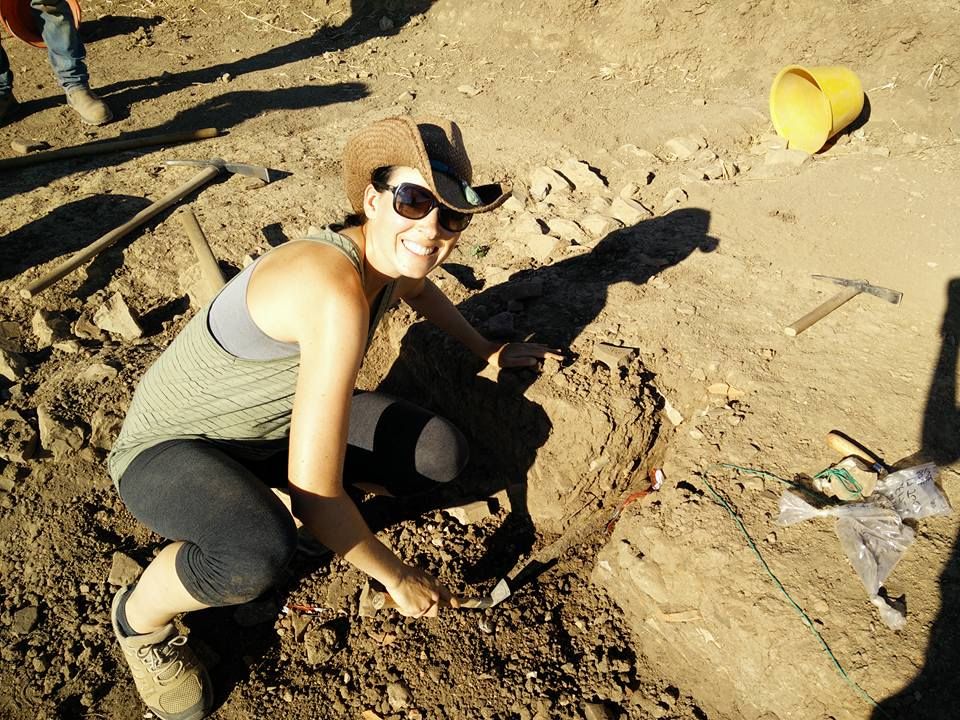 woman with pickaxe at archaeology dig